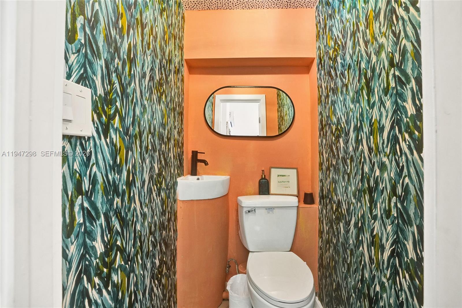 9181 Byron Avenue Surfside, FL 33154 - Photo 21 of 51 a bathroom with a toilet and a sink