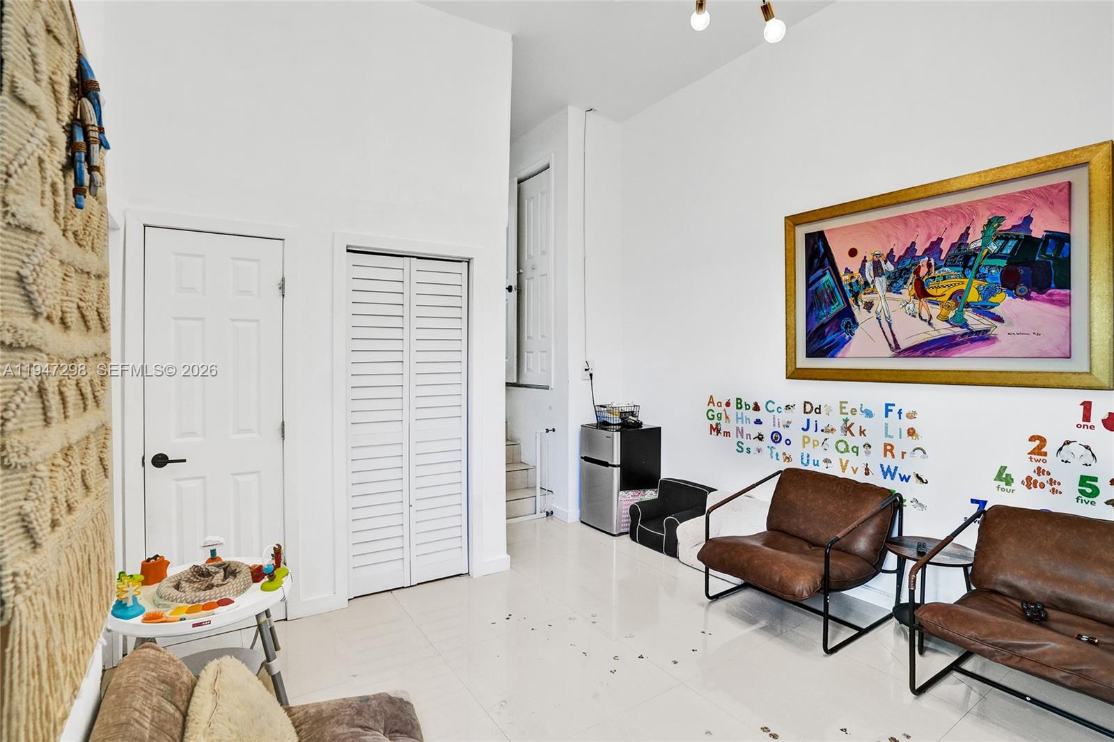 9181 Byron Avenue Surfside, FL 33154 - Photo 23 of 51 a living room with furniture and wall paintings