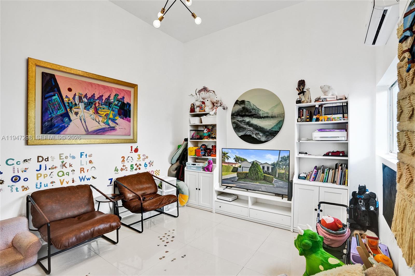 9181 Byron Avenue Surfside, FL 33154 - Photo 24 of 51 a bedroom with furniture and a lamp