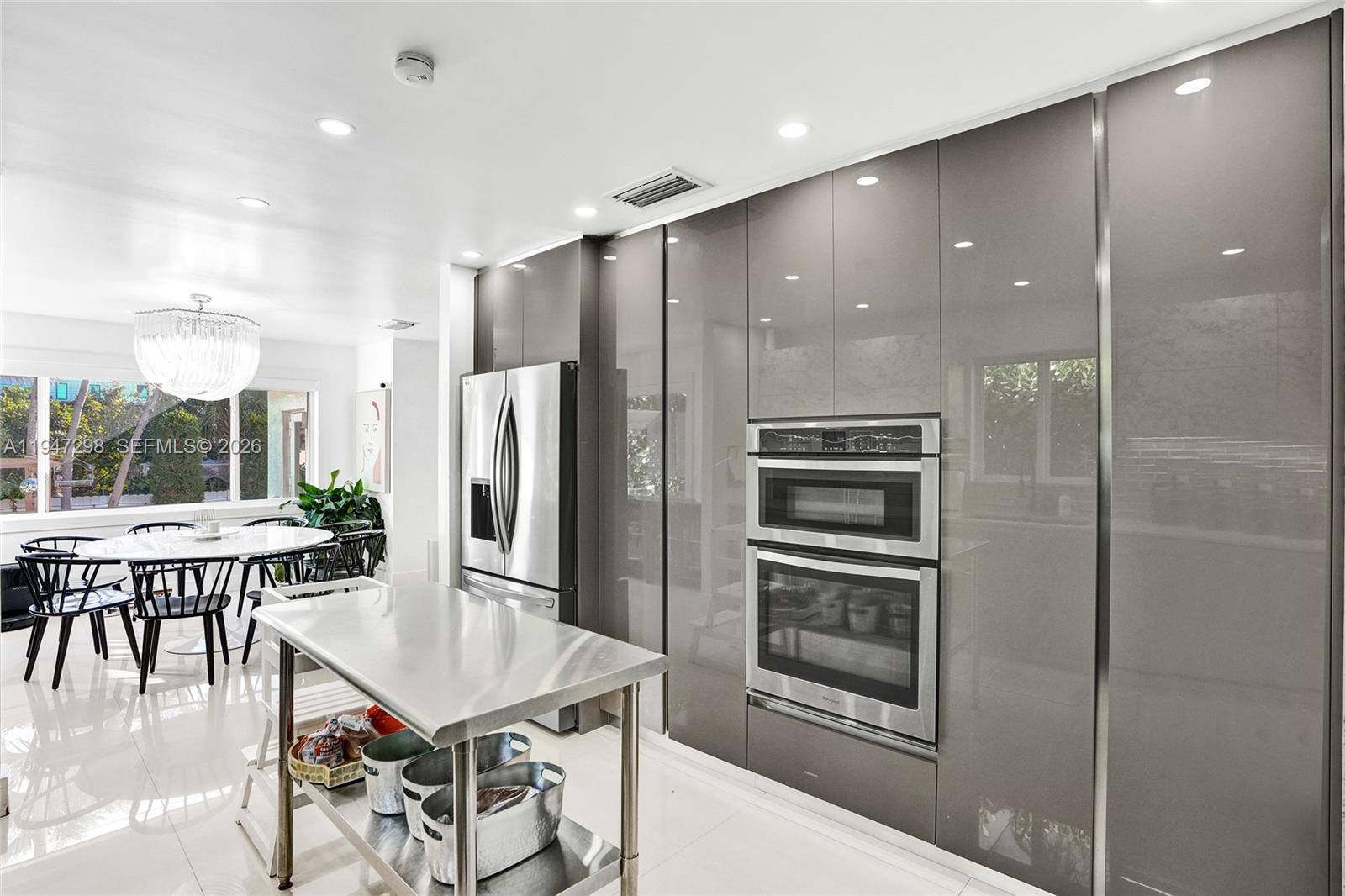 9181 Byron Avenue Surfside, FL 33154 - Photo 26 of 51 a kitchen with a table and chairs