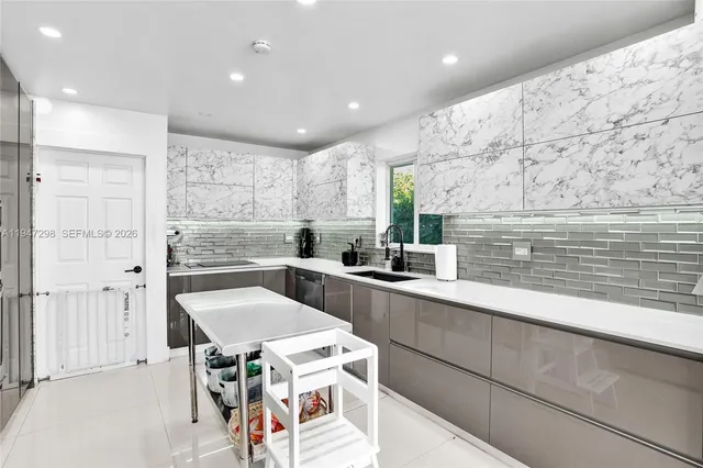 a kitchen with a sink a stove a refrigerator and cabinets