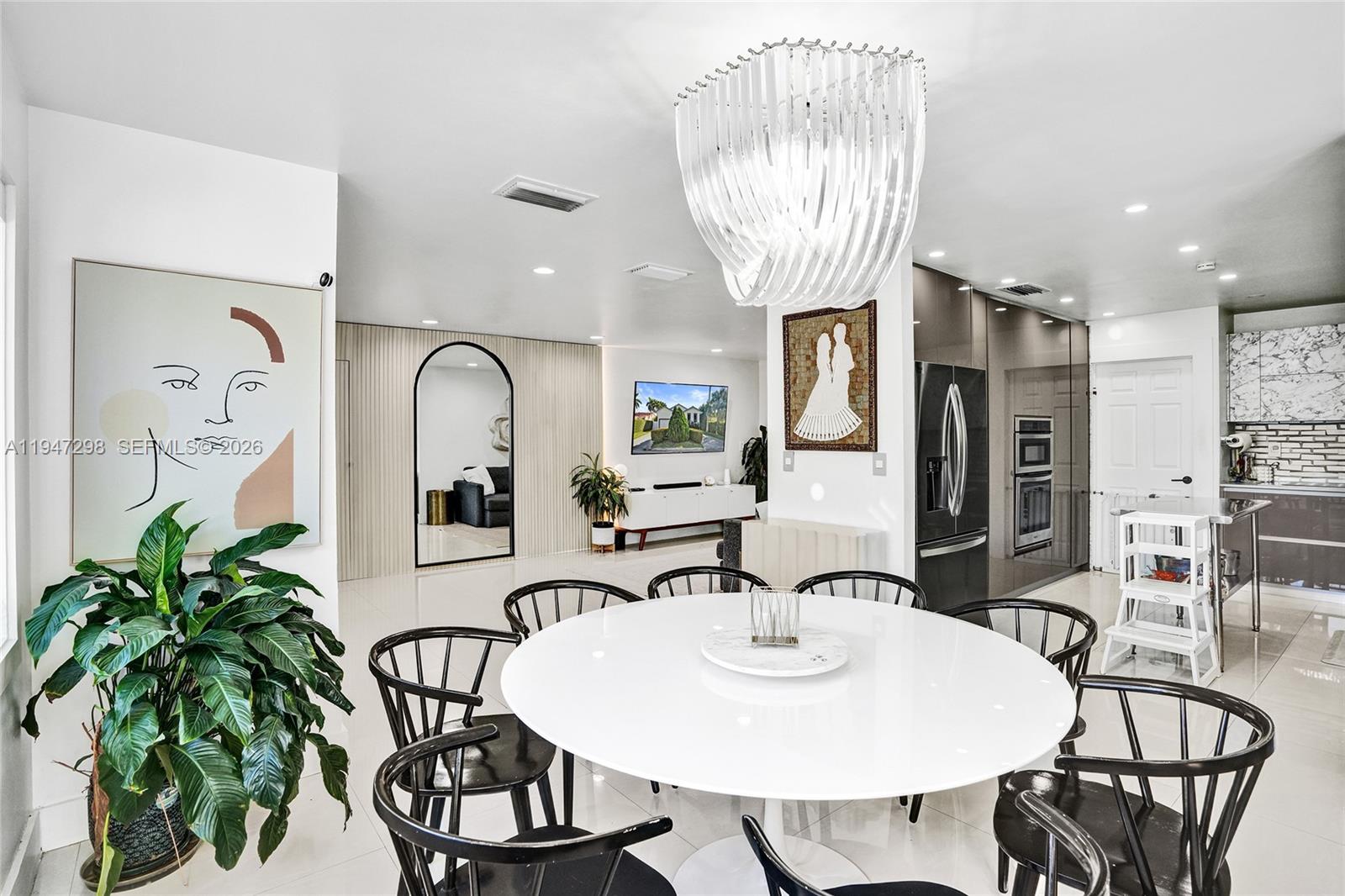 9181 Byron Avenue Surfside, FL 33154 - Photo 30 of 51 a view of a dining room with furniture and chandelier