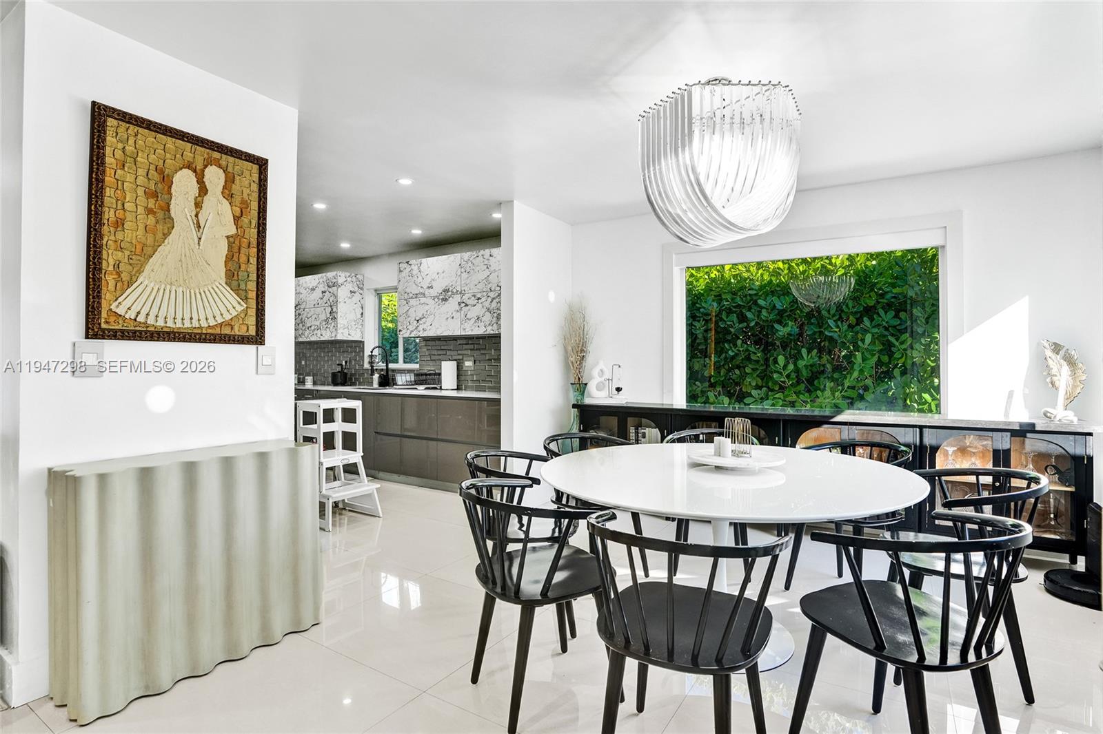 9181 Byron Avenue Surfside, FL 33154 - Photo 32 of 51 a view of a dining room with furniture window and wooden floor
