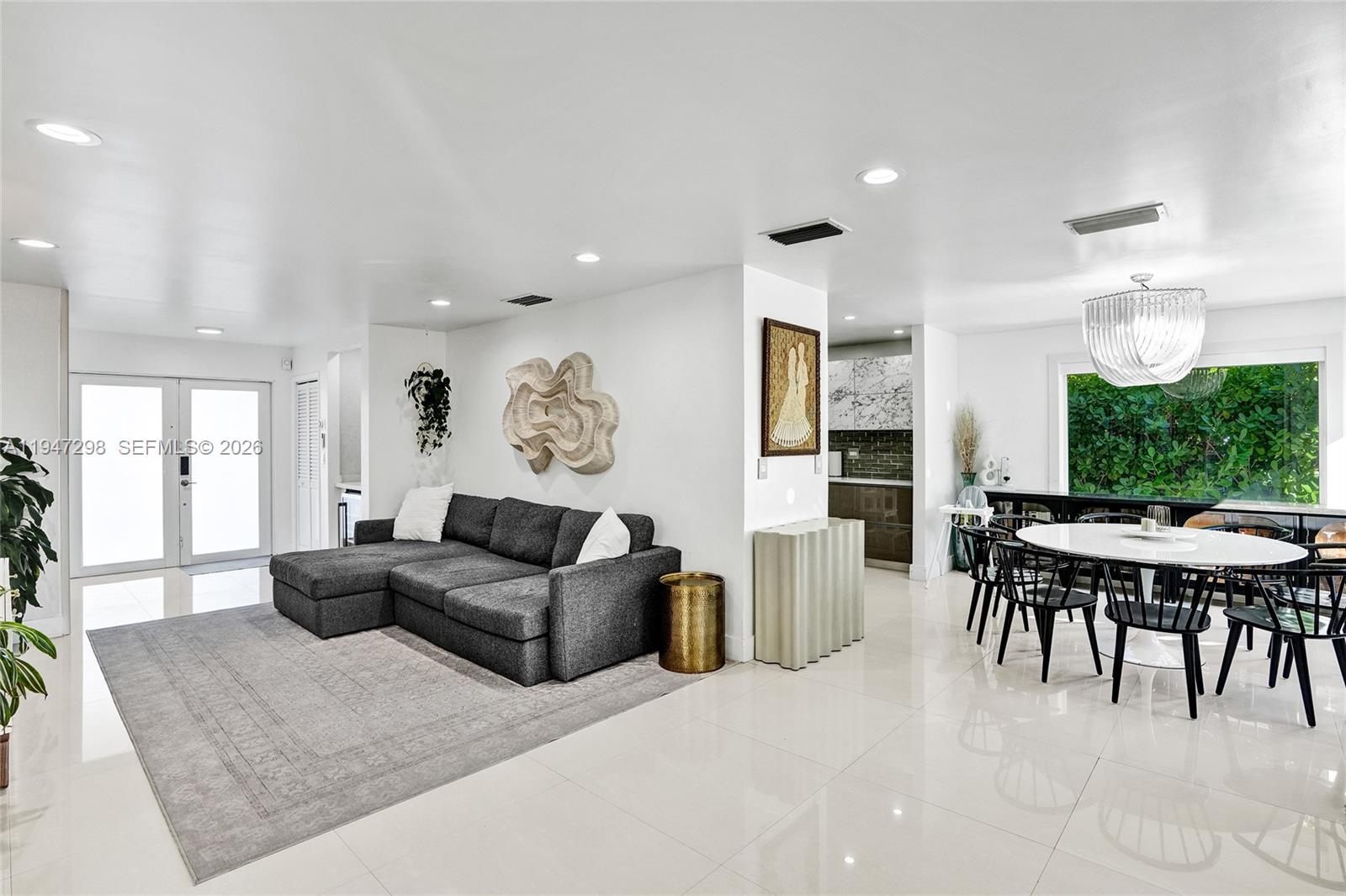 9181 Byron Avenue Surfside, FL 33154 - Photo 36 of 51 a living room with furniture and a large window