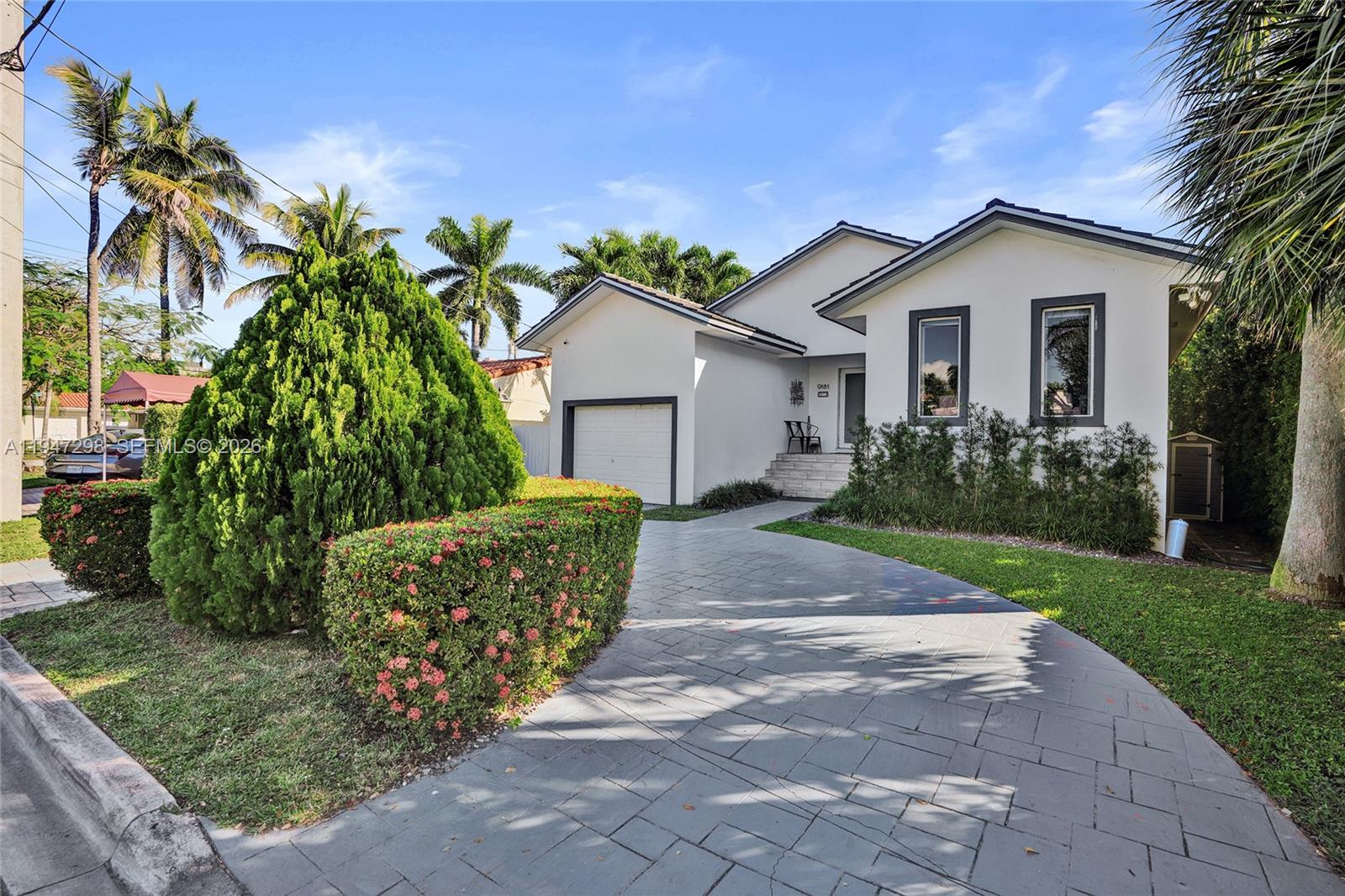 9181 Byron Avenue Surfside, FL 33154 - Photo 4 of 51 a view of a house with a yard and potted plants