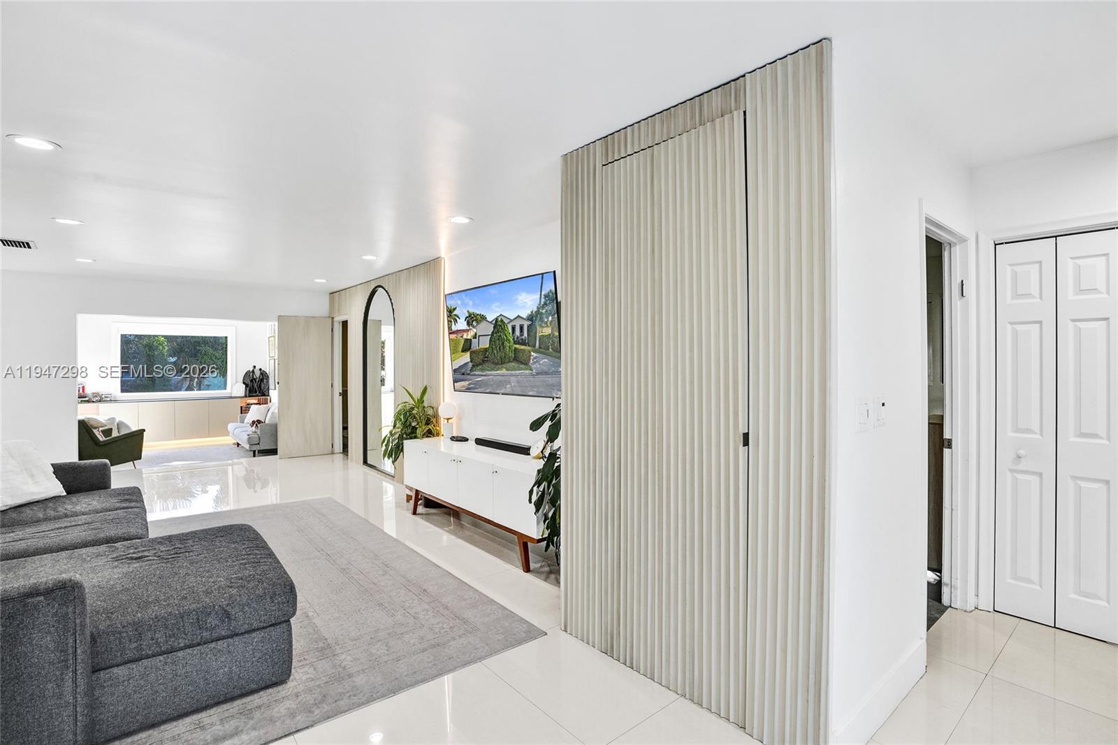 9181 Byron Avenue Surfside, FL 33154 - Photo 42 of 51 a living room with furniture and a large window