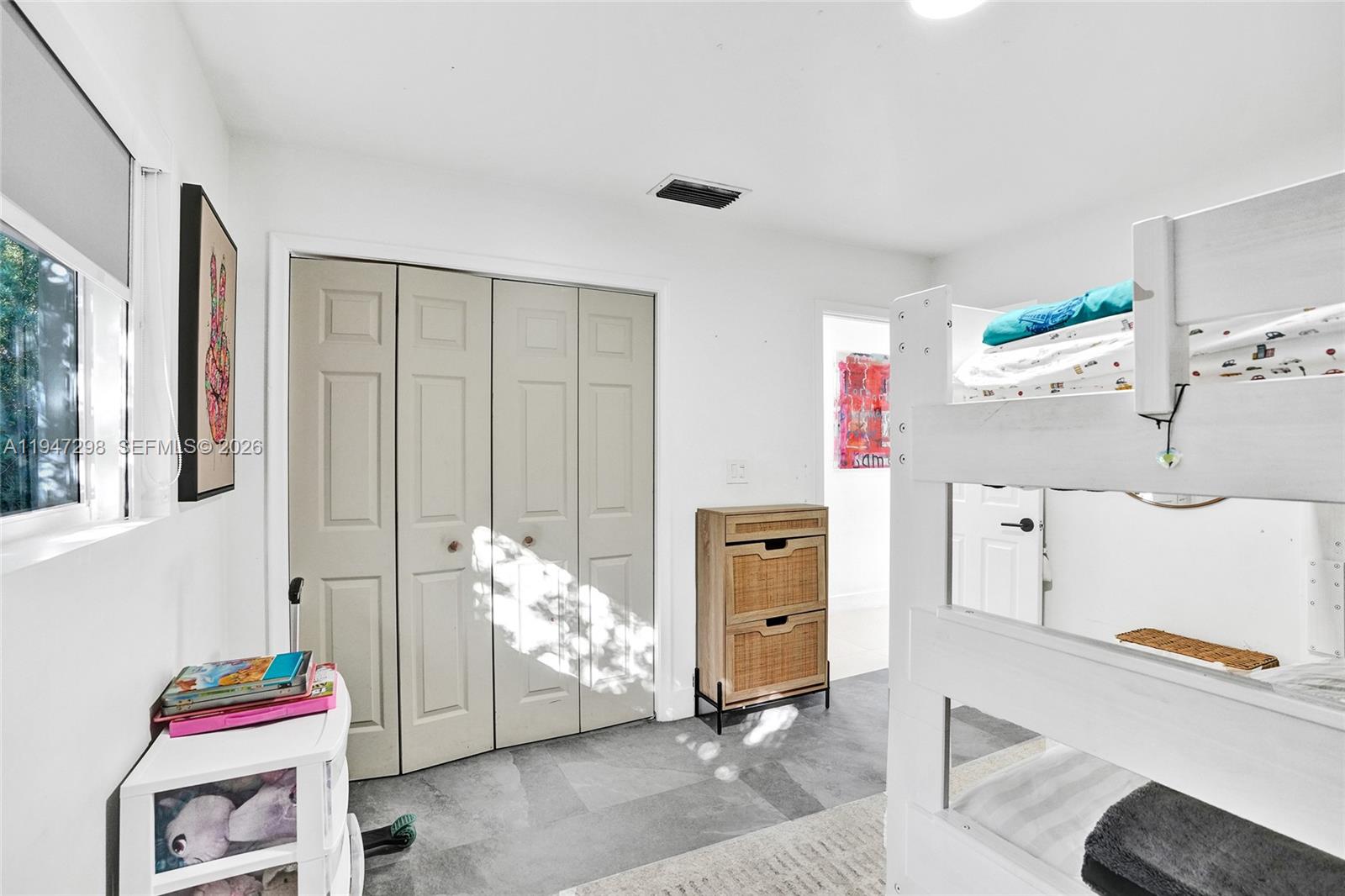 9181 Byron Avenue Surfside, FL 33154 - Photo 44 of 51 a bed room with a bed and a window