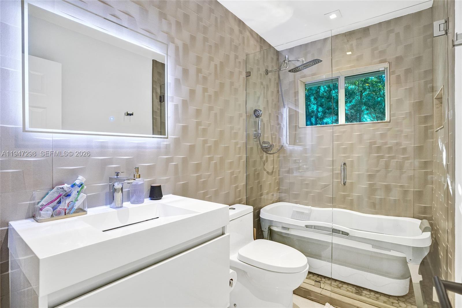 9181 Byron Avenue Surfside, FL 33154 - Photo 48 of 51 a bathroom with a sink toilet and shower