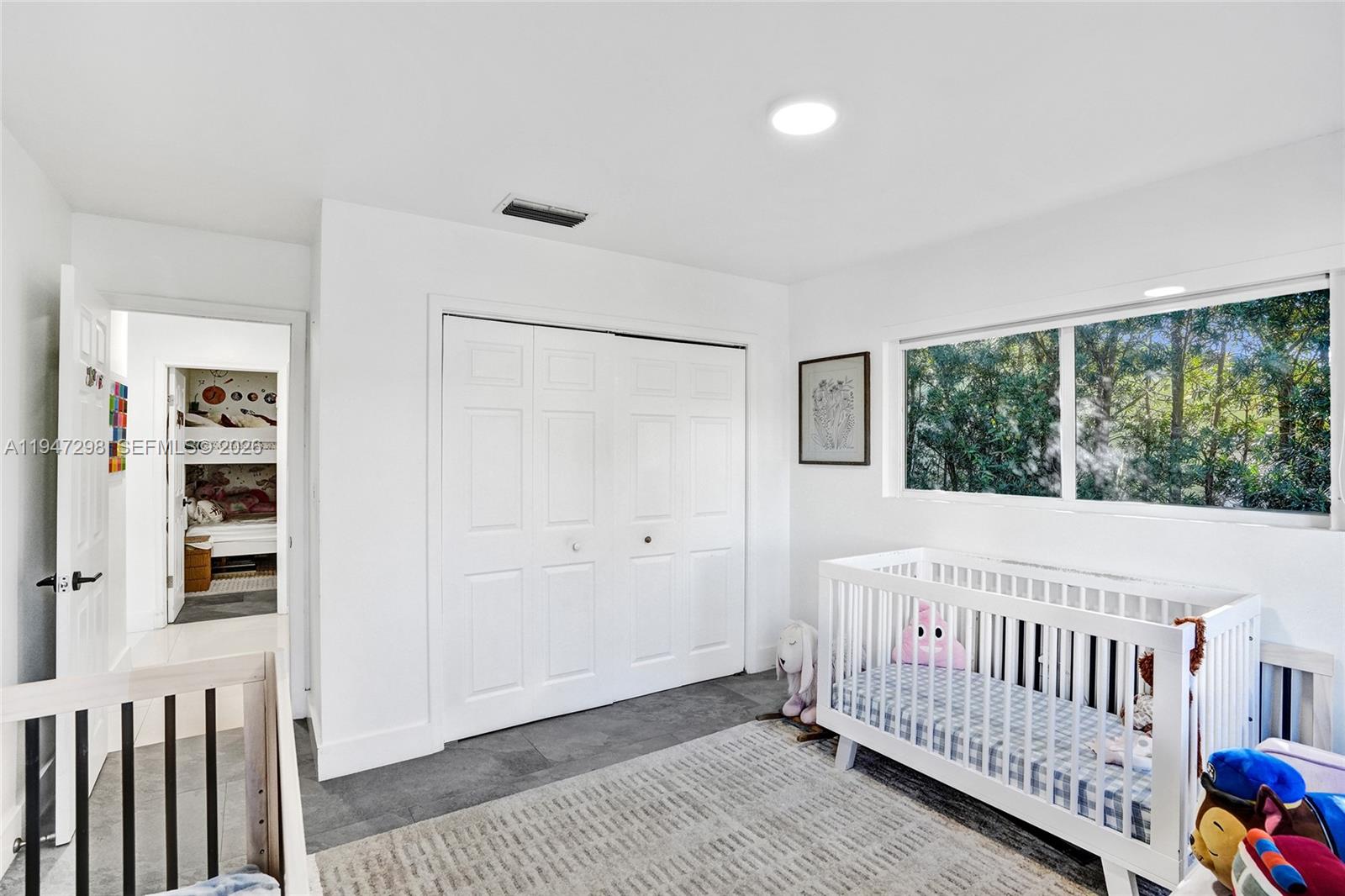 9181 Byron Avenue Surfside, FL 33154 - Photo 49 of 51 a view of a bedroom with wooden floor and windows
