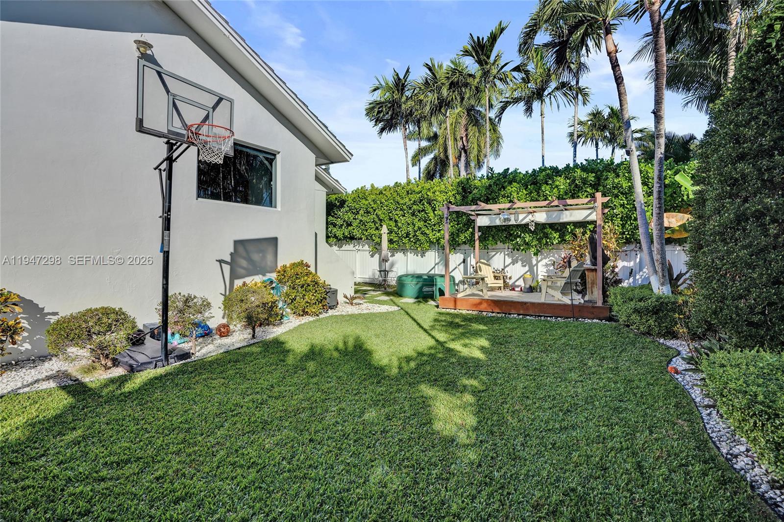 9181 Byron Avenue Surfside, FL 33154 - Photo 9 of 51 a view of a chair and table in the garden