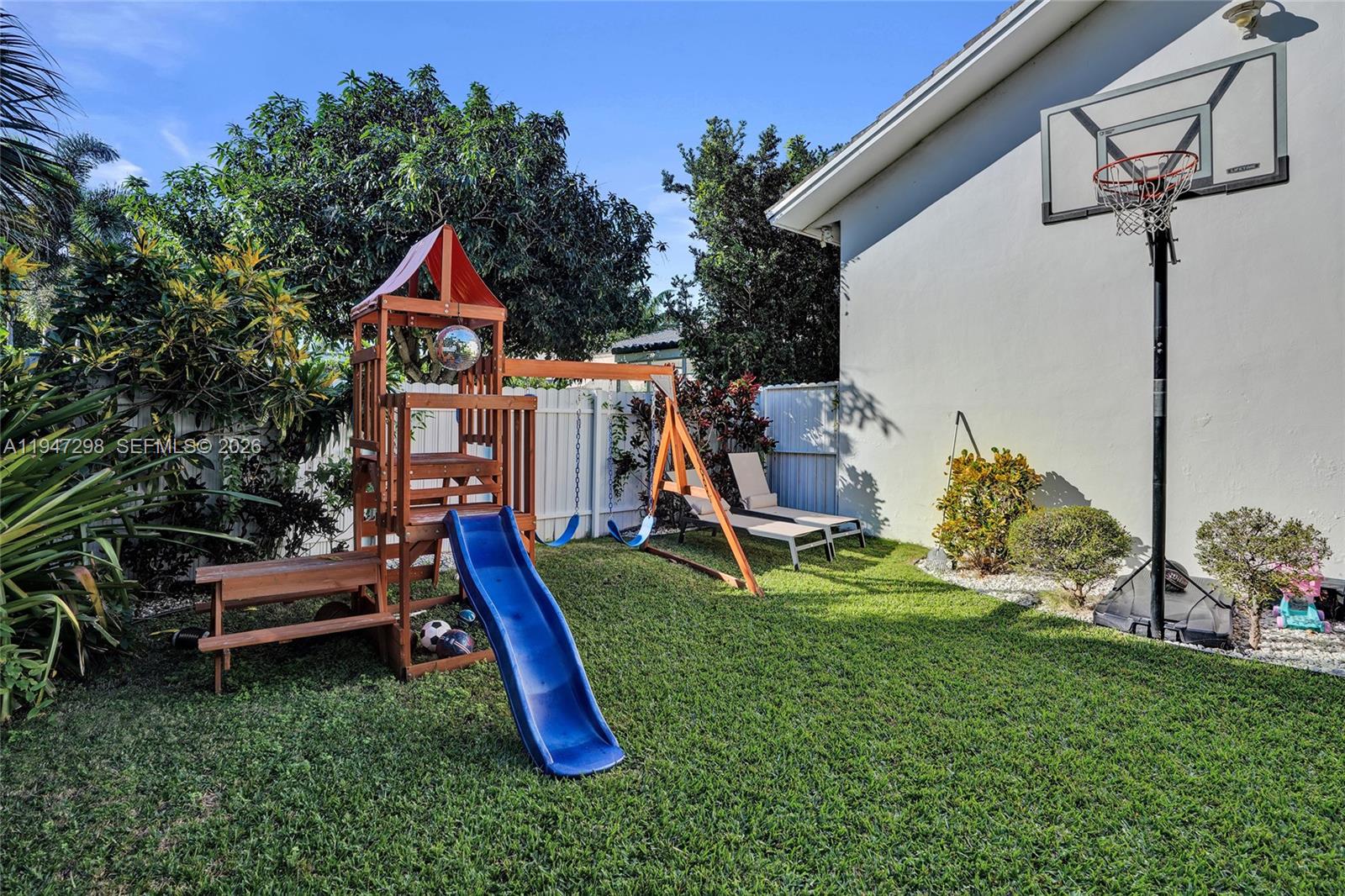 9181 Byron Avenue Surfside, FL 33154 - Photo 10 of 51 a view of a house with a backyard and a slide