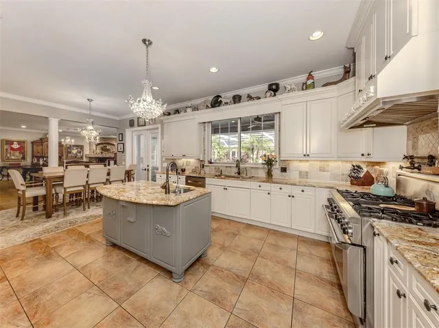 a kitchen with stainless steel appliances granite countertop a stove and a sink