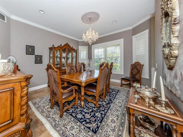 a view of a patio with table and chairs under an umbrella