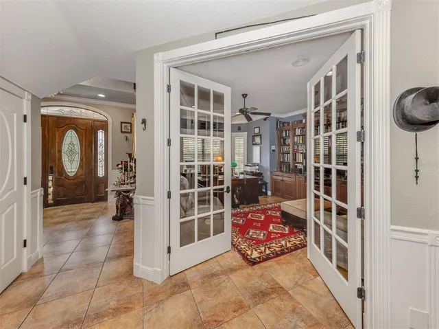 a living room with furniture a chandelier and a rug