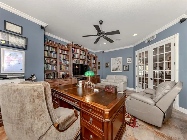 a room with pool table and windows