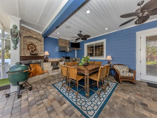 a kitchen with stainless steel appliances a stove a sink and white cabinets