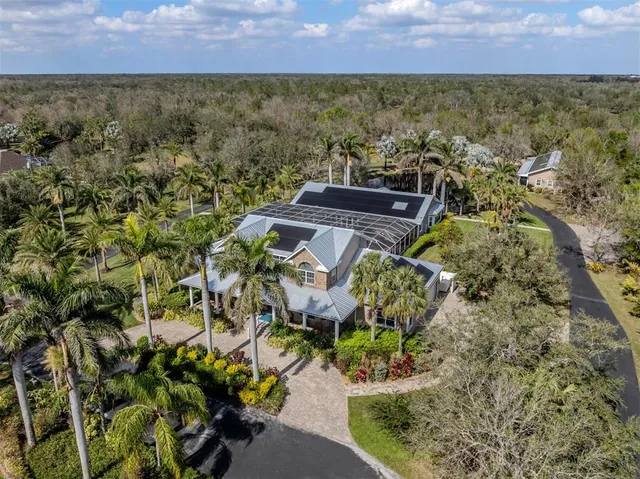 a large kitchen with stainless steel appliances kitchen island granite countertop a stove and a refrigerator
