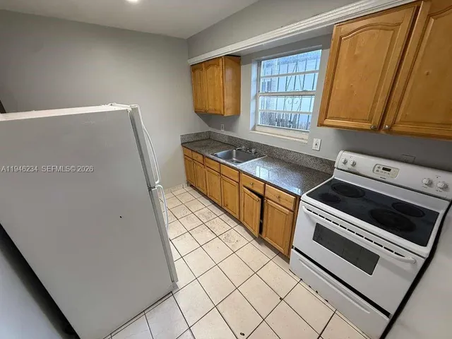 a kitchen with stainless steel appliances a stove a sink and a microwave