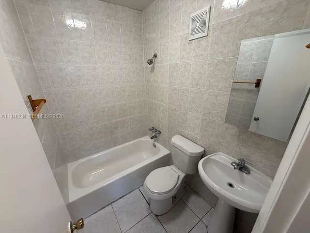 a bathroom with a sink a toilet and bathtub