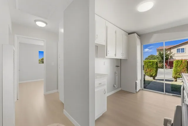 a view of a kitchen with furniture and an entryway