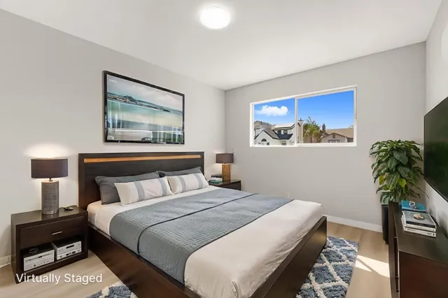 a bedroom with bed and a potted plant