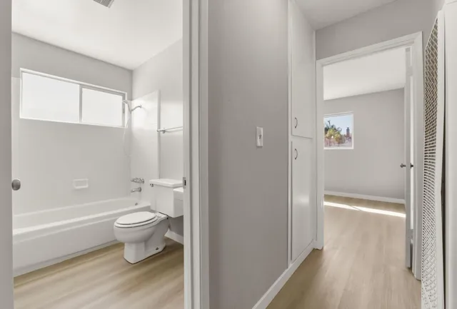 a bathroom with a toilet and a shower