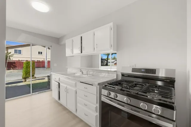 a kitchen with stainless steel appliances granite countertop a stove and a refrigerator