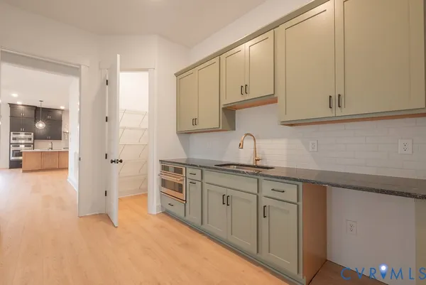 a kitchen with granite countertop white cabinets and white appliances