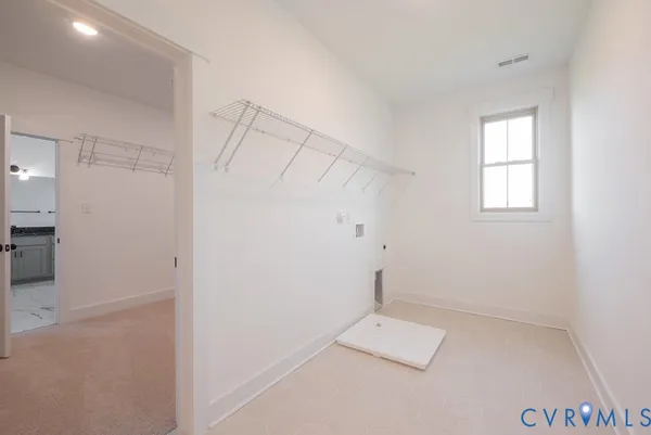 an empty room with a white cabinet and mirrors
