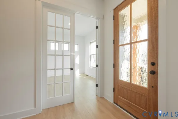a view of an entryway with wooden floor
