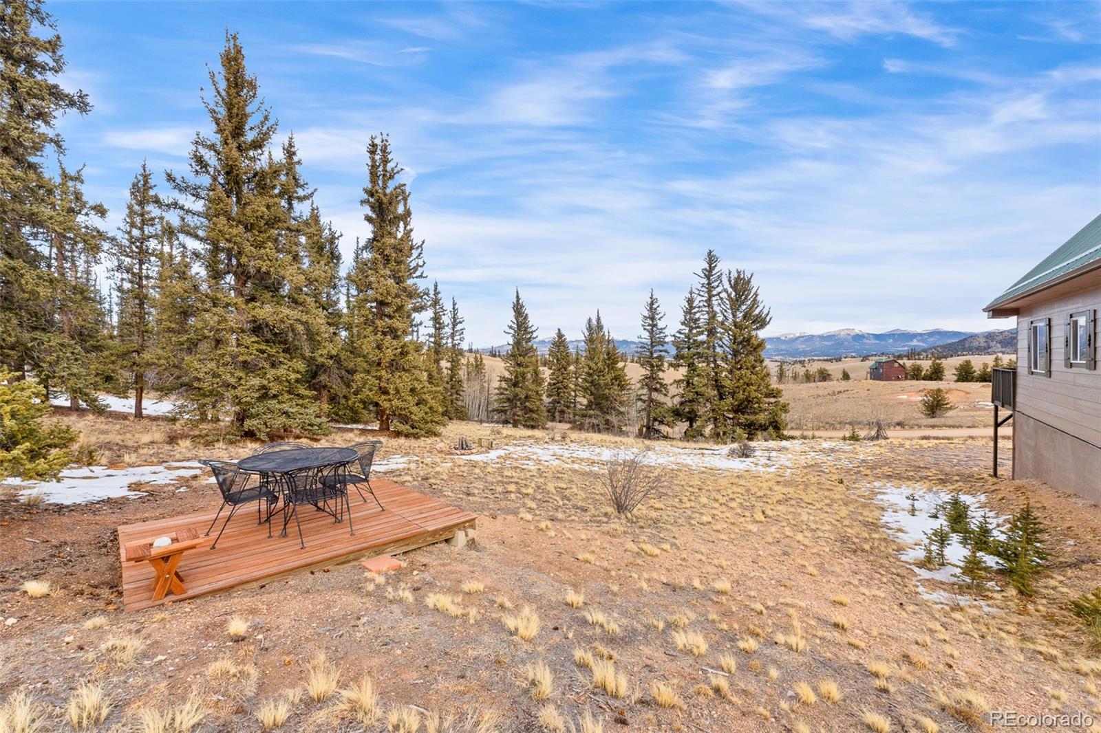 4018 Arrowhead Drive Como, CO 80456 - Photo 12 of 50 a view of a terrace with lawn chairs and wooden fence