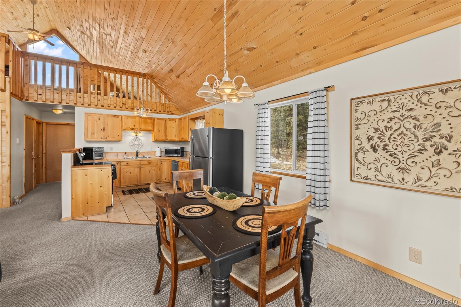 4018 Arrowhead Drive Como, CO 80456 - Photo 23 of 50 a view of a dining room with furniture window and outside view