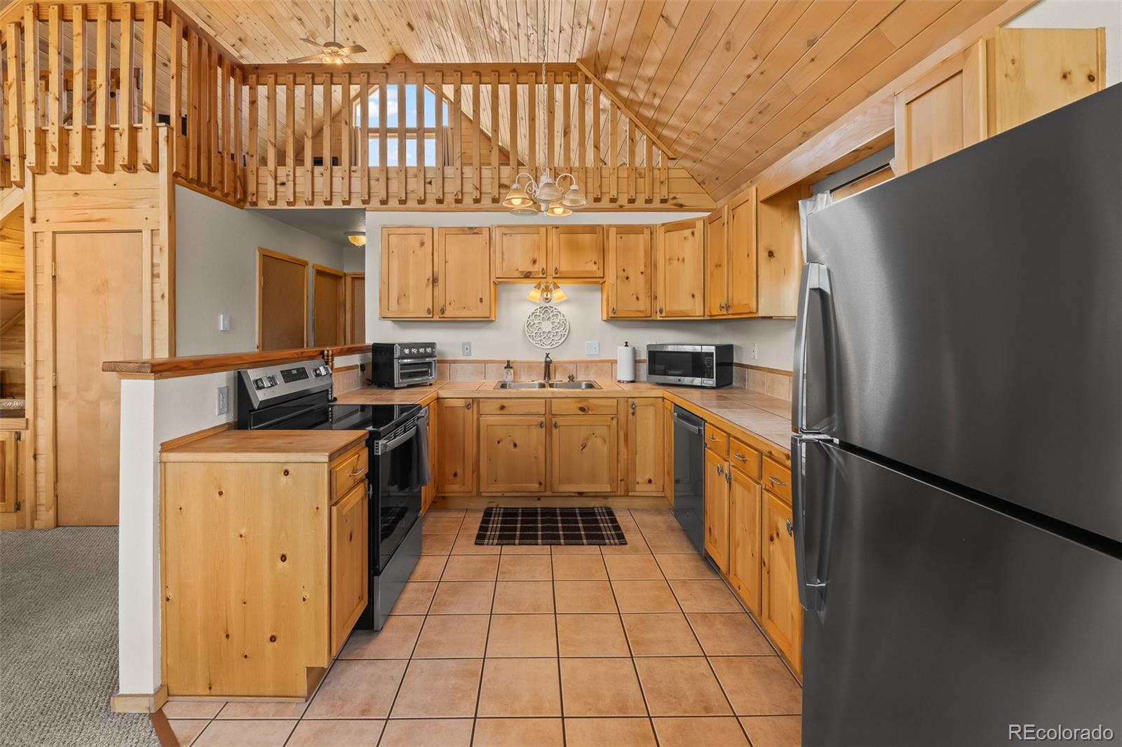 4018 Arrowhead Drive Como, CO 80456 - Photo 25 of 50 a kitchen with stainless steel appliances granite countertop a stove a sink dishwasher and a refrigerator with wooden floor