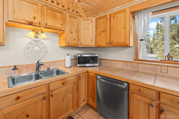 a kitchen with stainless steel appliances granite countertop a sink a stove and refrigerator