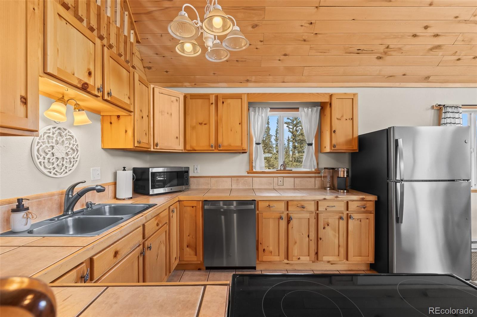 4018 Arrowhead Drive Como, CO 80456 - Photo 28 of 50 a kitchen with stainless steel appliances granite countertop a sink a stove and refrigerator