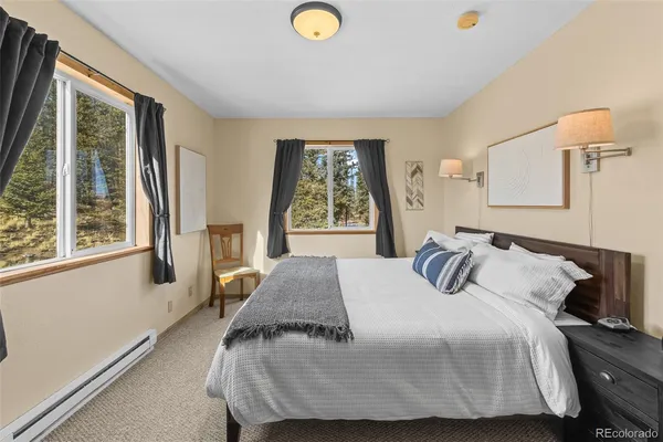 a spacious bedroom with a bed and a window
