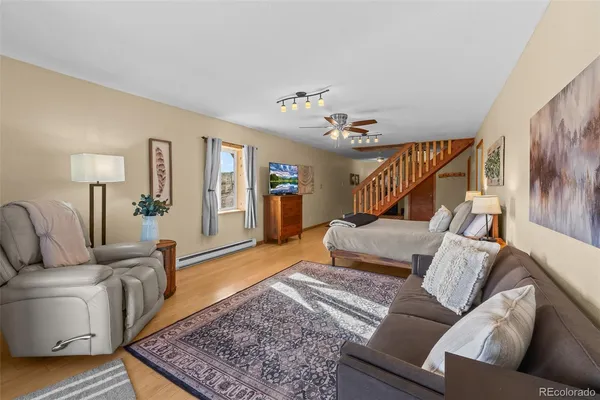 a living room with furniture and a chandelier