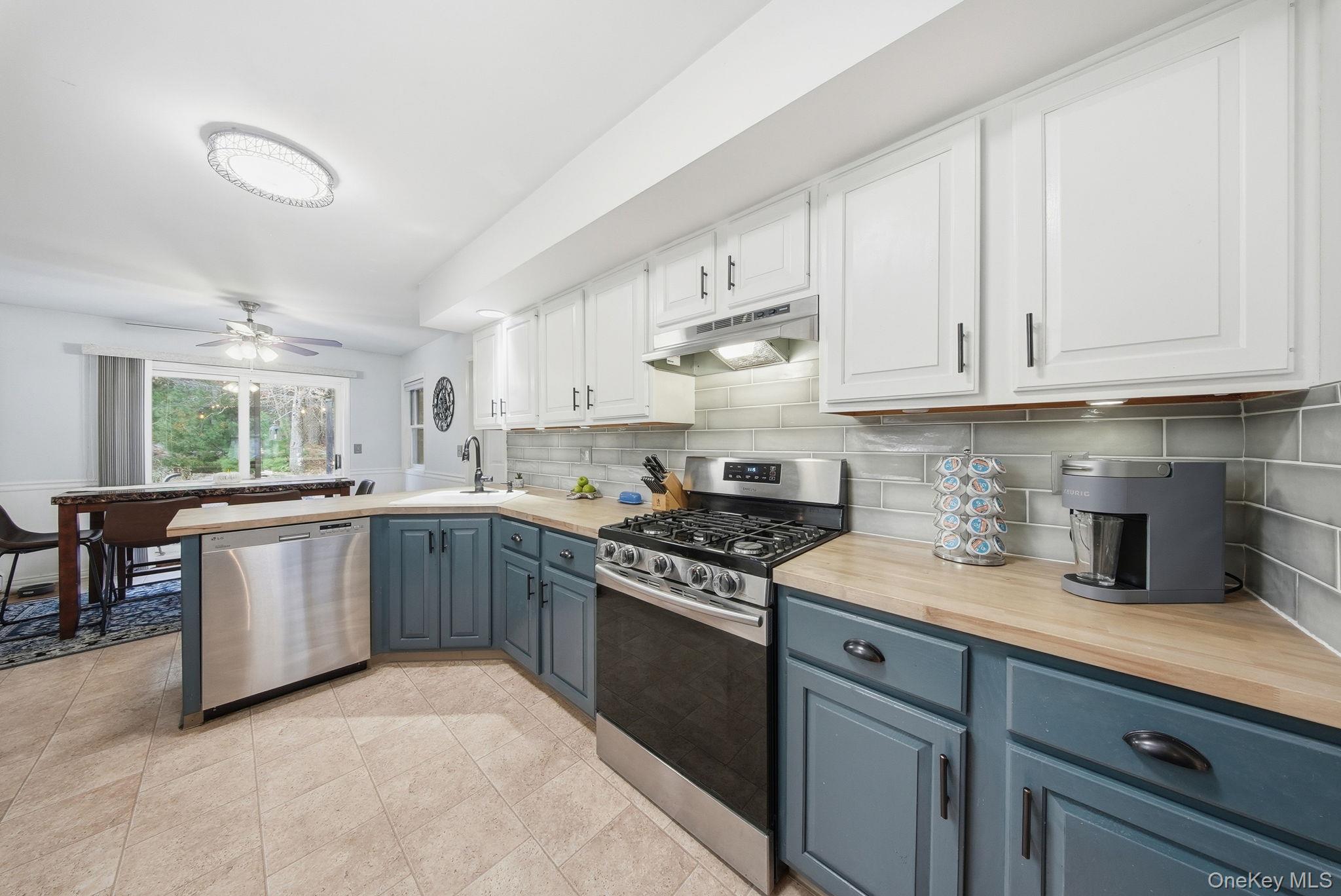 44 Florio Earl Road Wurtsboro, NY 12790 - Photo 14 of 42 a kitchen with granite countertop white cabinets and white appliances