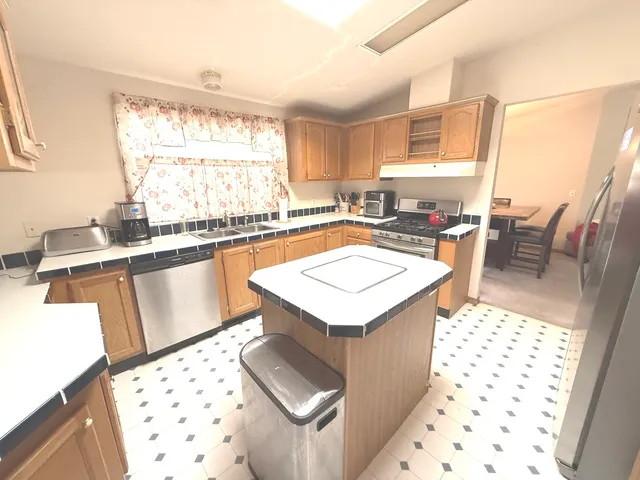 a kitchen with a sink a stove a table and chairs