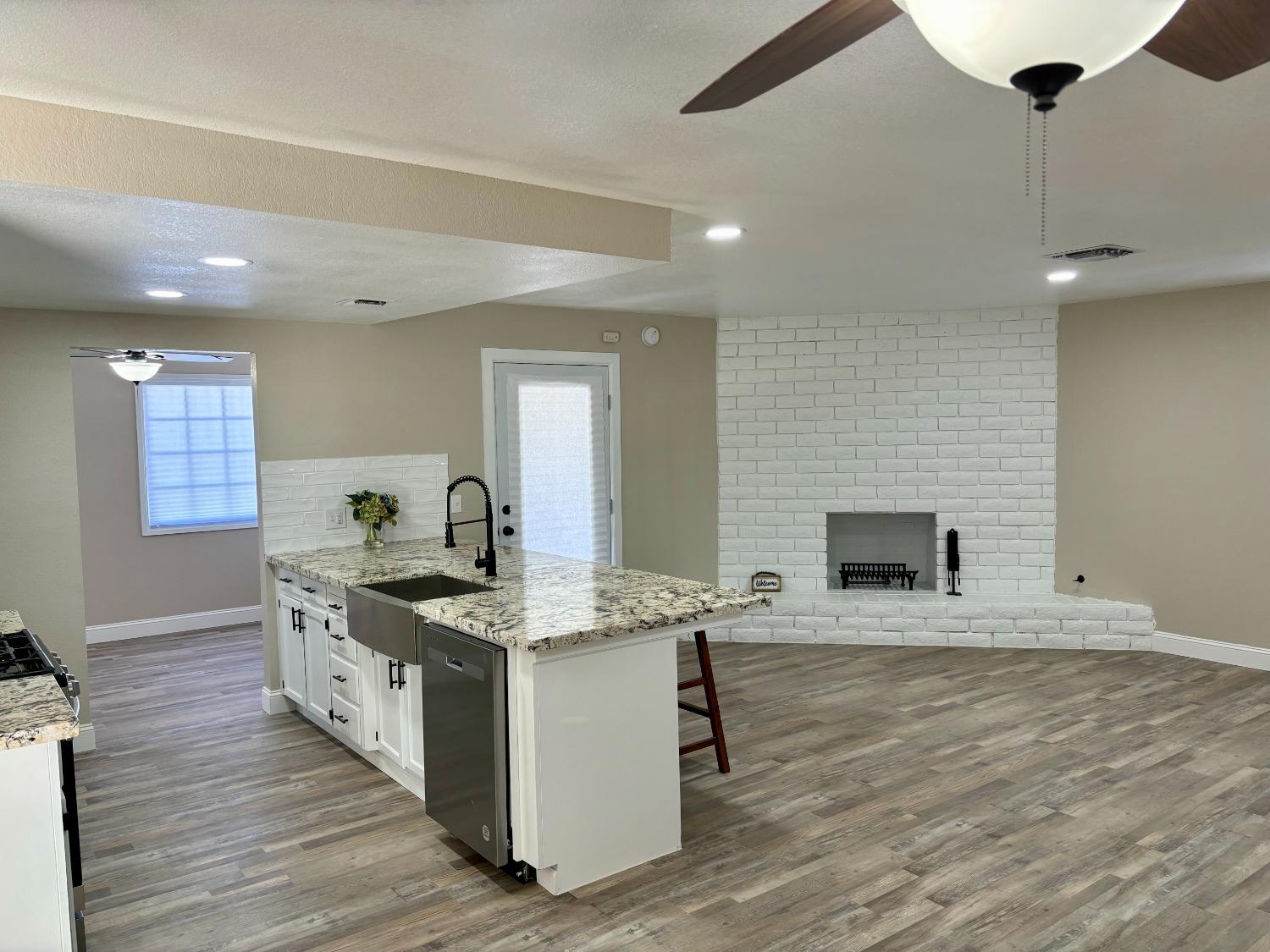 910 Cedar Lane Lemoore, CA 93245 - Photo 13 of 32 a kitchen with a stove and a wooden floor