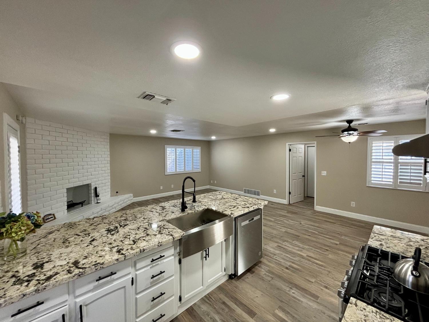 910 Cedar Lane Lemoore, CA 93245 - Photo 17 of 32 a kitchen with stainless steel appliances granite countertop a sink and a stove