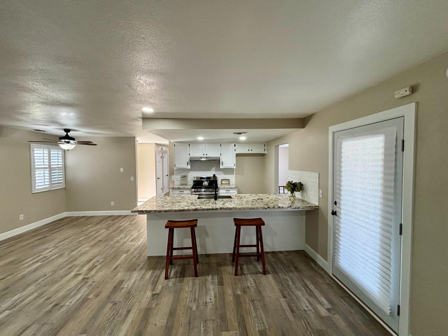 910 Cedar Lane Lemoore, CA 93245 - Photo 20 of 32 a view of a kitchen with a table and chairs in it