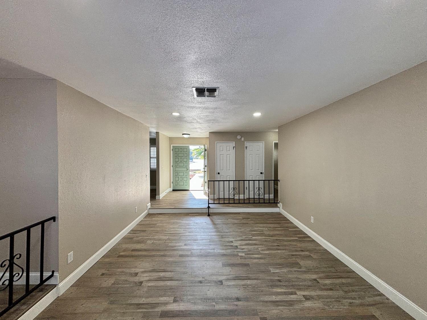 910 Cedar Lane Lemoore, CA 93245 - Photo 22 of 32 a view of empty room with wooden floor
