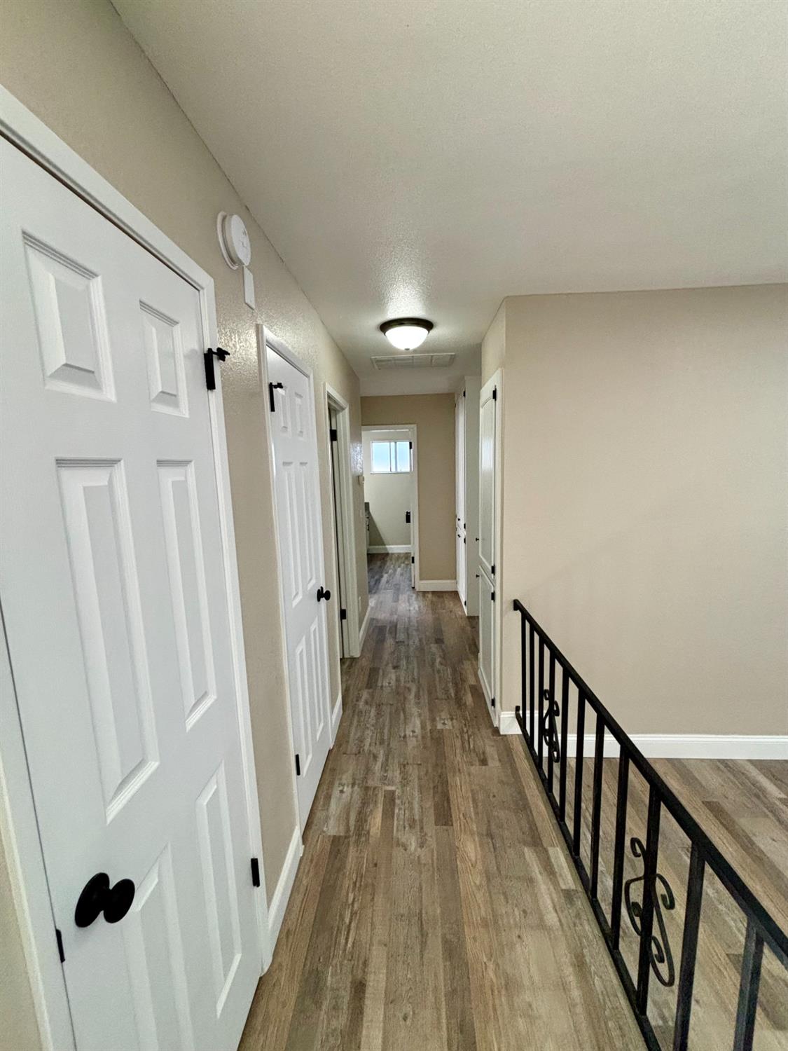 910 Cedar Lane Lemoore, CA 93245 - Photo 25 of 32 a view of a hallway with wooden floor and staircase