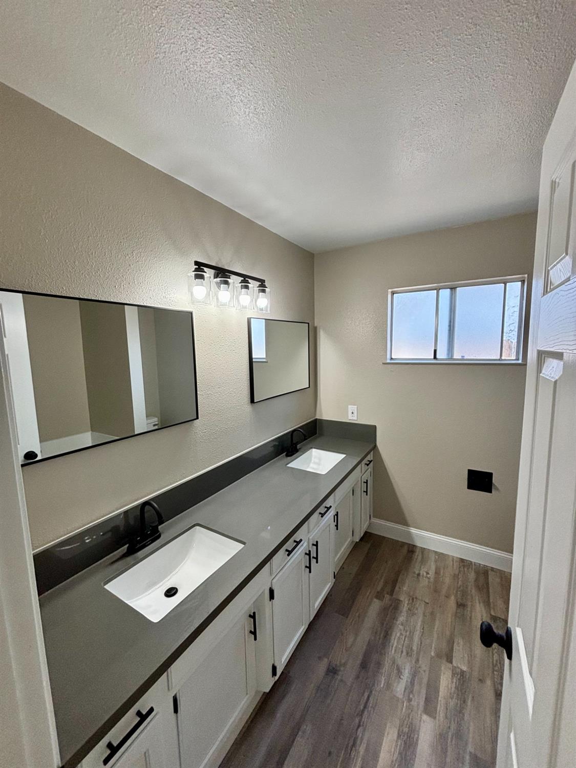910 Cedar Lane Lemoore, CA 93245 - Photo 28 of 32 a bathroom with a double vanity sink and mirror