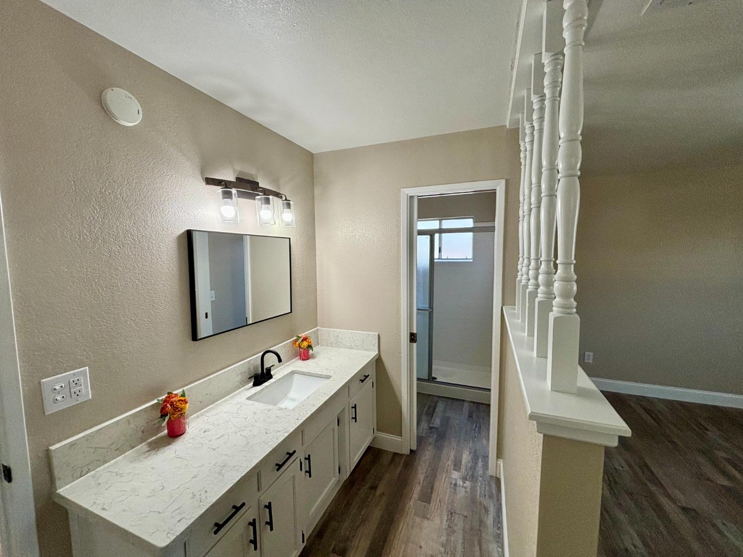 910 Cedar Lane Lemoore, CA 93245 - Photo 31 of 32 a en suite bathroom with a double vanity sink mirror and