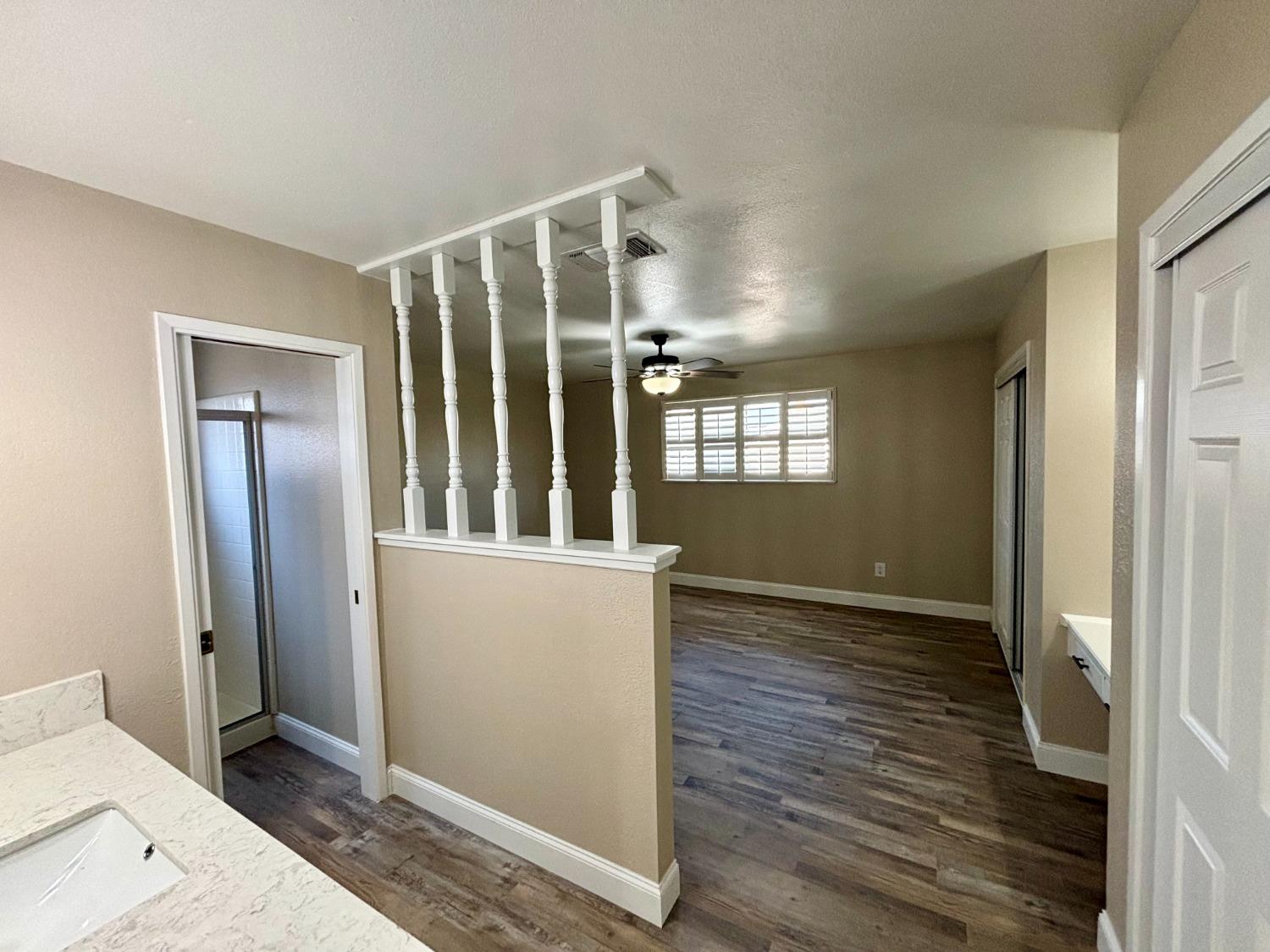 910 Cedar Lane Lemoore, CA 93245 - Photo 32 of 32 a view of an empty room with wooden floor and a window