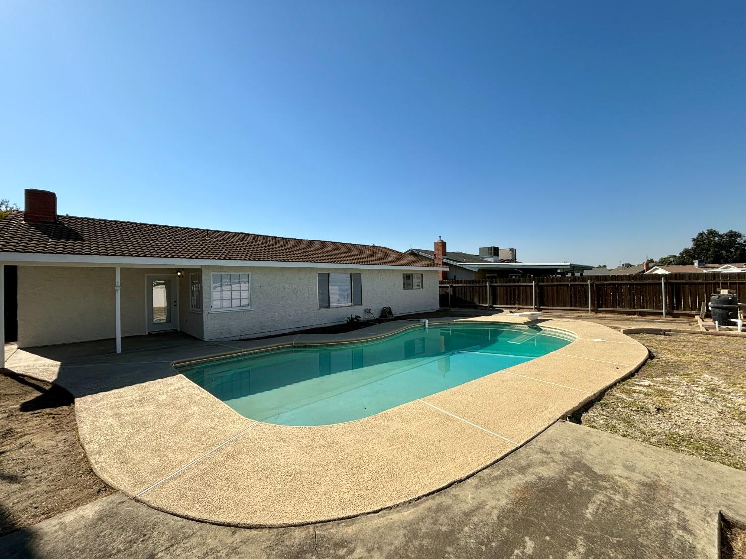 910 Cedar Lane Lemoore, CA 93245 - Photo 5 of 32 a view of a house with a backyard
