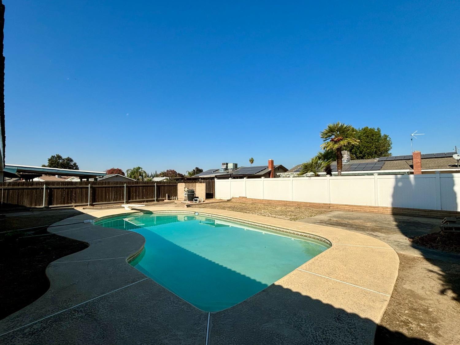 910 Cedar Lane Lemoore, CA 93245 - Photo 6 of 32 a view of a swimming pool with an ocean view