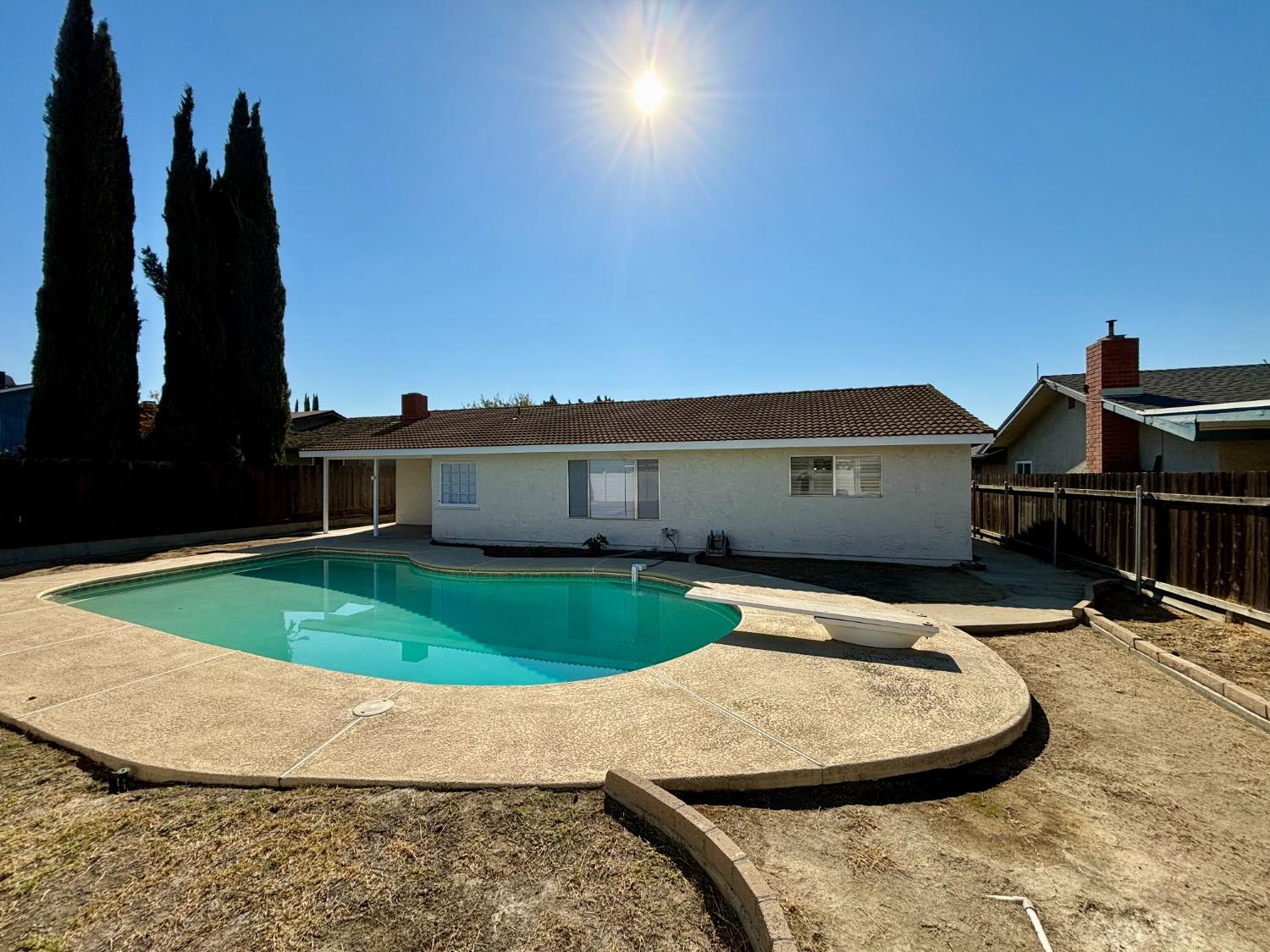 910 Cedar Lane Lemoore, CA 93245 - Photo 8 of 32 a backyard of a house with barbeque oven